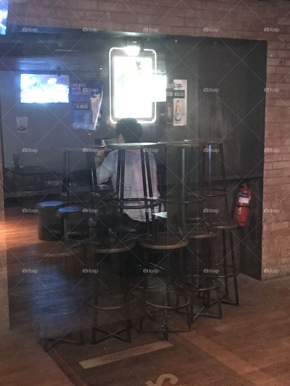Focus gamer... too focus until his friends build a castle of bar stools around him without him noticing the whole process and still engross with his game