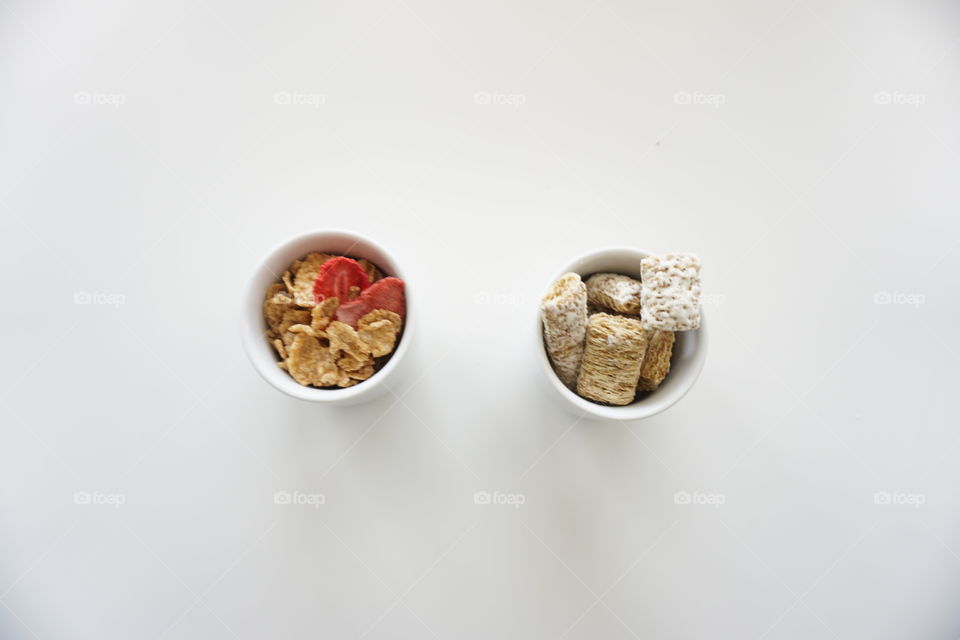 Two cups with different cereals 