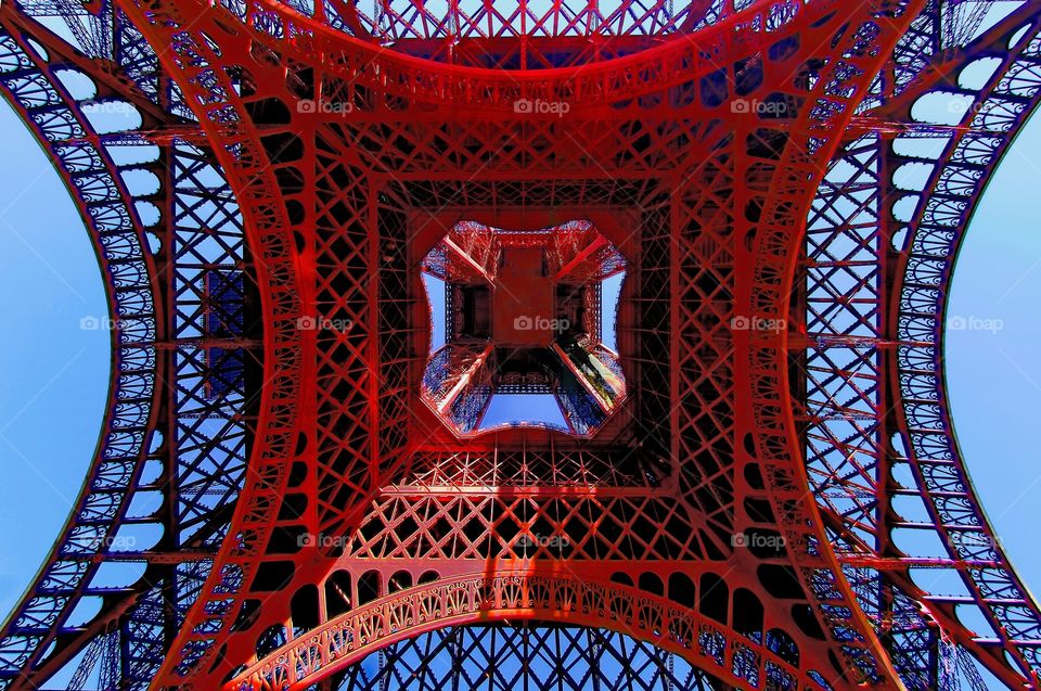 Looking up from directly beneath the Eiffel Tower / Tour Eiffel in Paris, France.