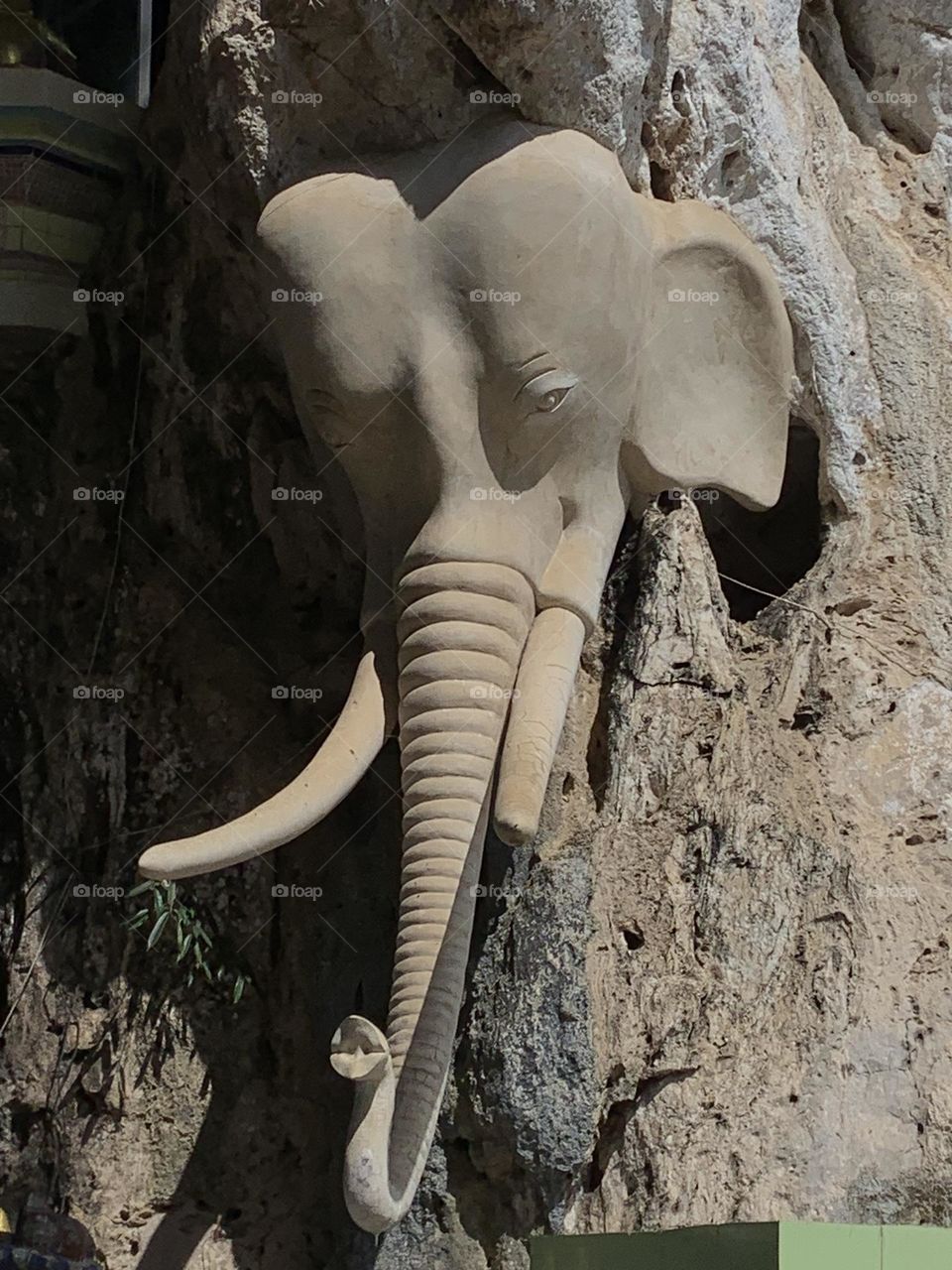 Stone elephant sculpture in Khao Rup Chang Temple