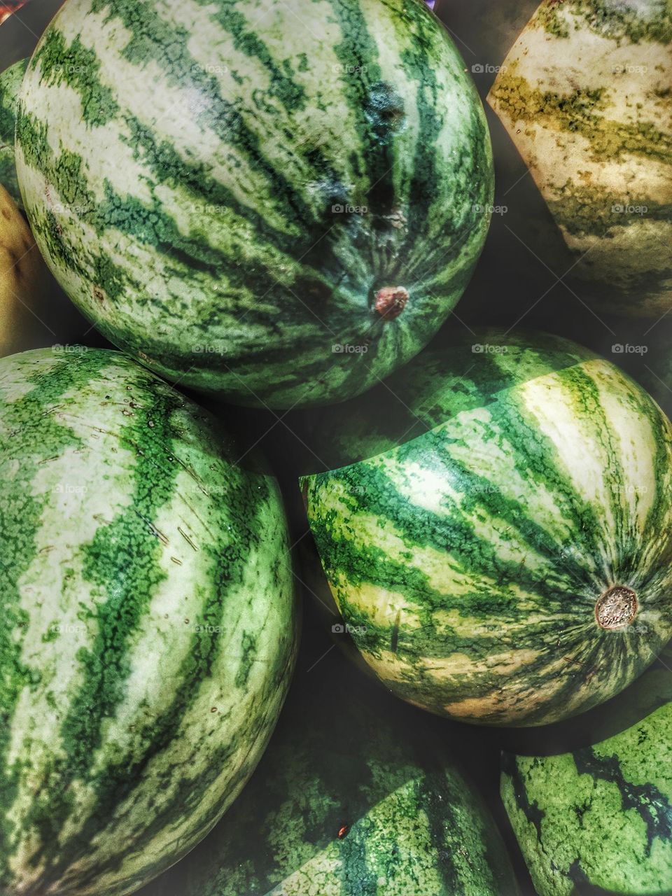 watermelon a sweet fruit, green on the outside and red on the inside.