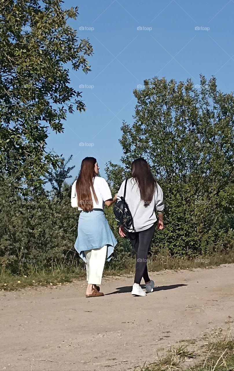 two womens friends walking outside
