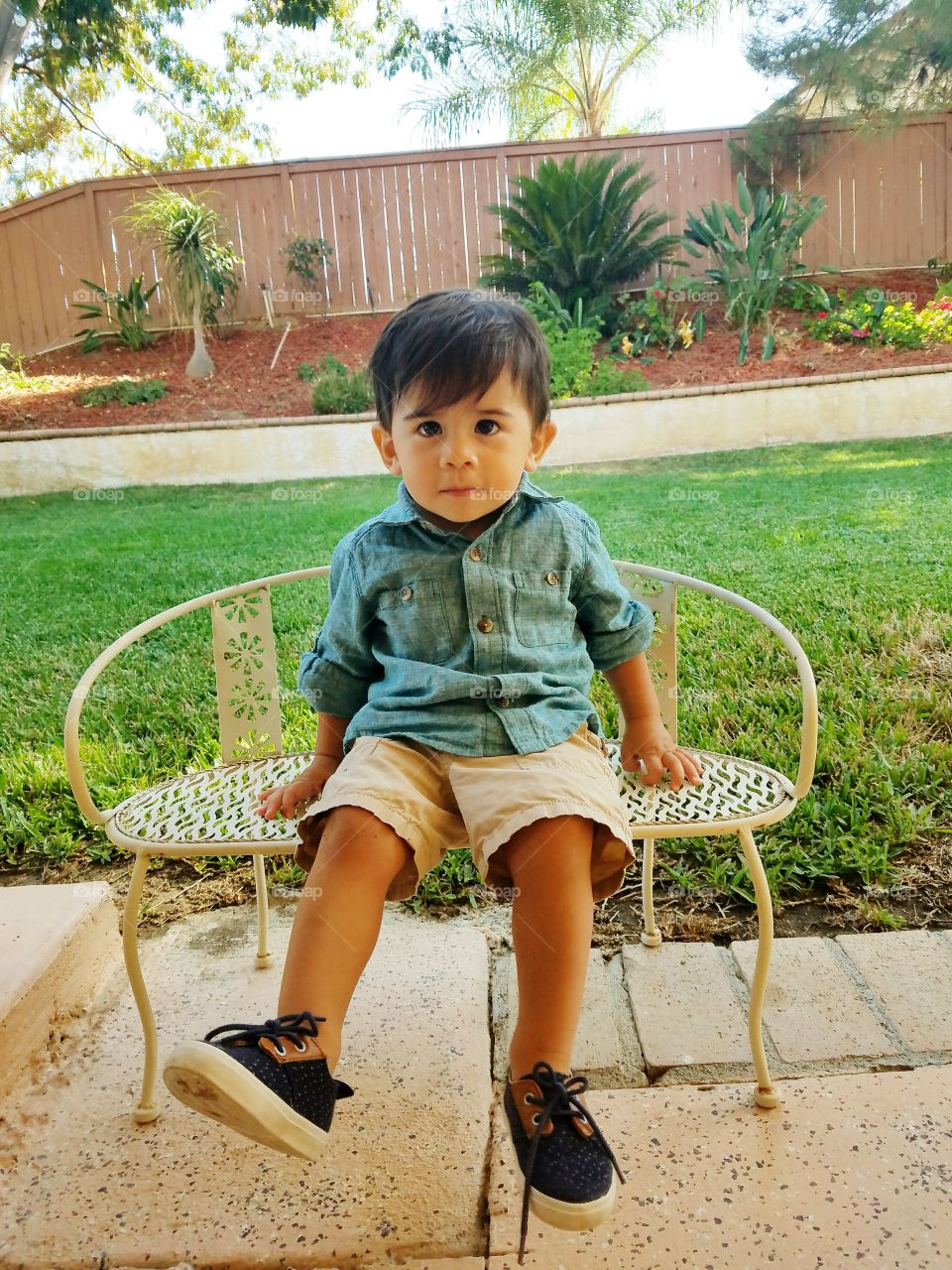 Cute boy sitting on chair