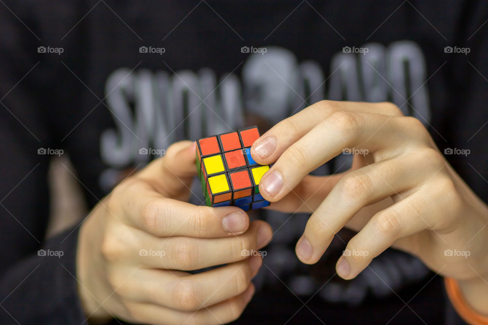 Child solving Rubik's Cube.