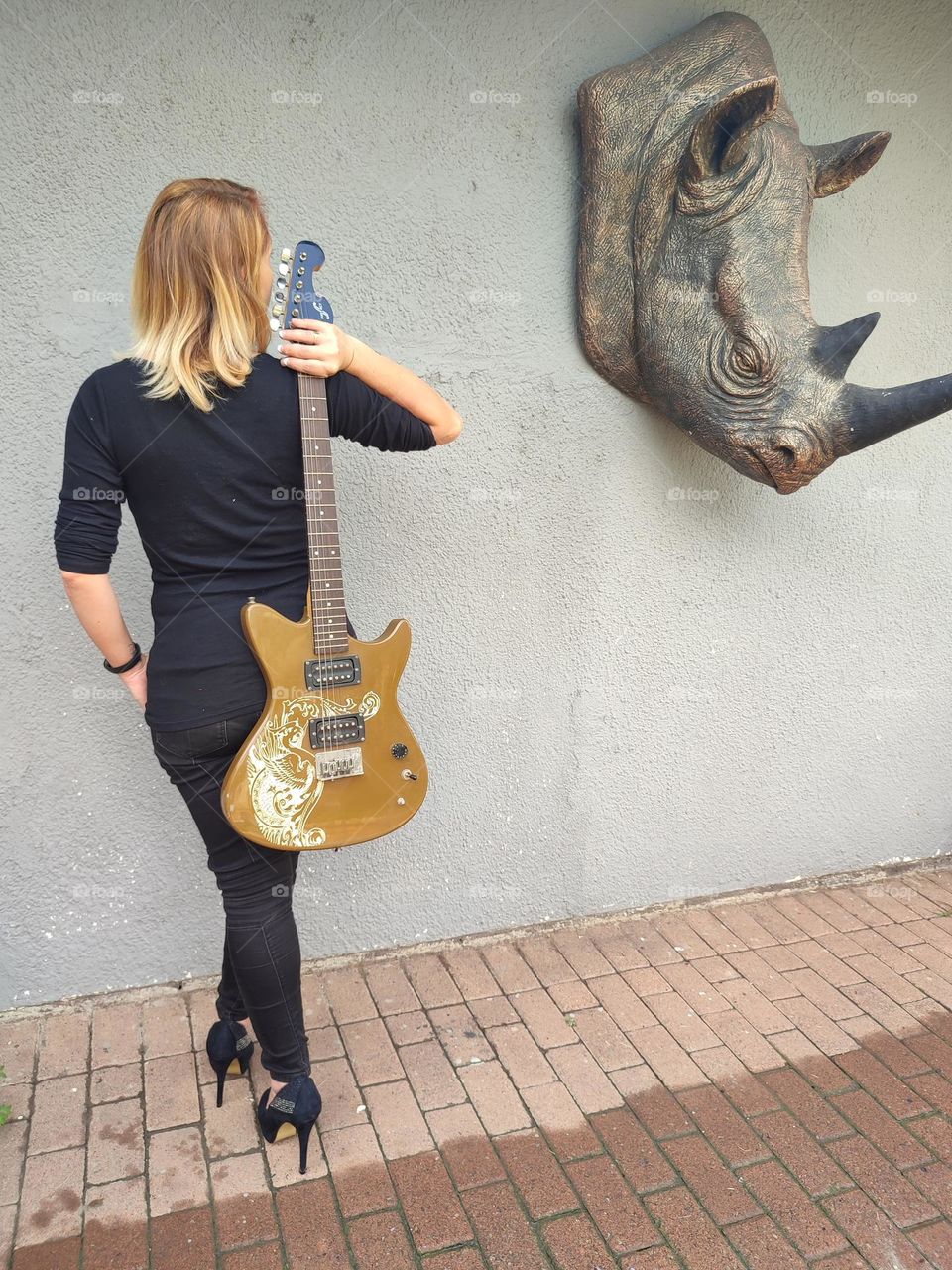 Female holding an Electric Guitar