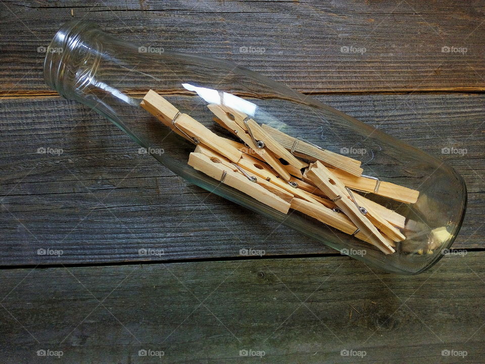 wooden clothespins in a glass bottle
