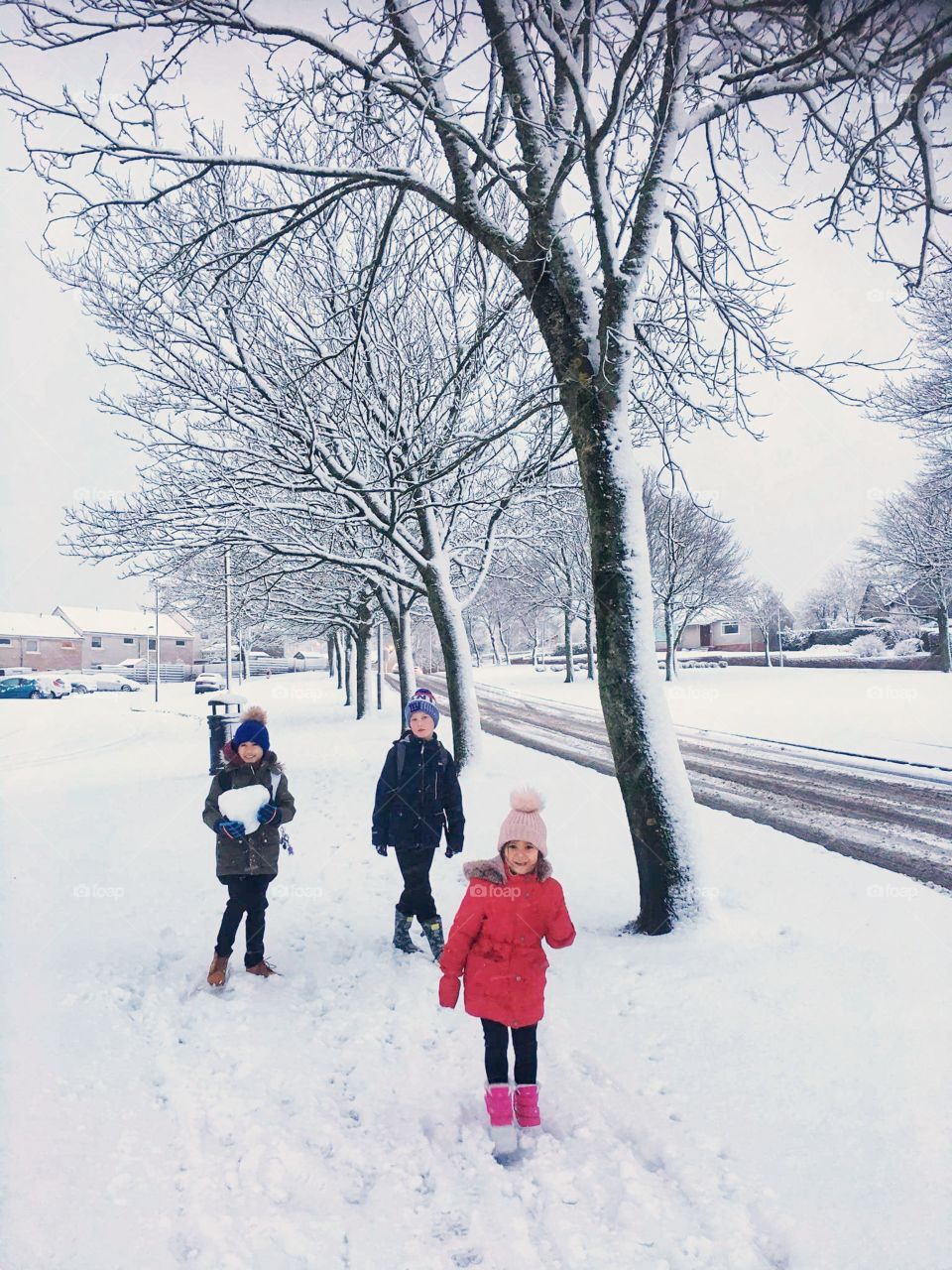 Children funning with snow