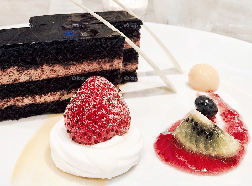 Dessert : Chocolate mousse cake with red berries sauce