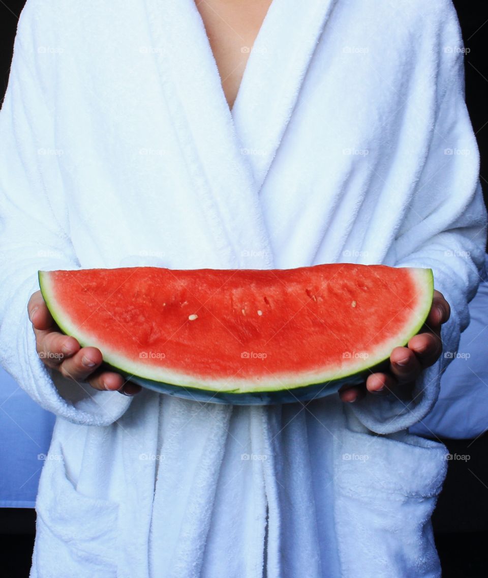 Woman holding watermelon slice