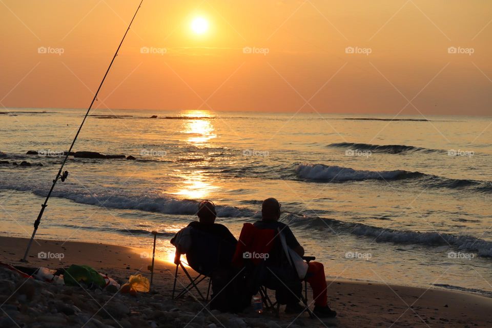 Fishermen sunset on the beach