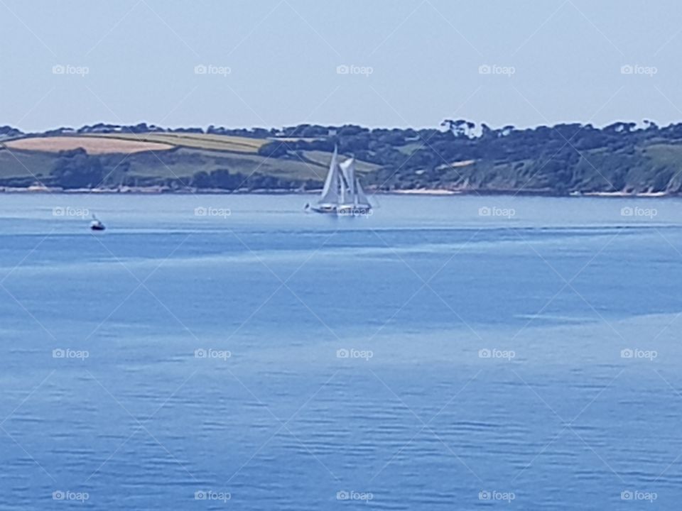 yacht sailing a calm sea on a beautiful sunny day