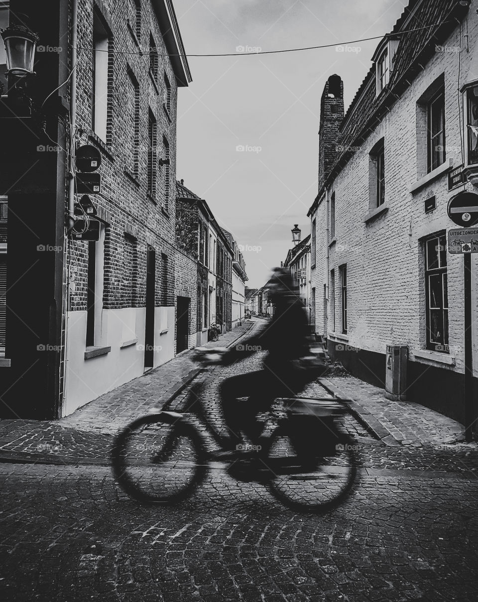a bike rider in streets of Bruges
