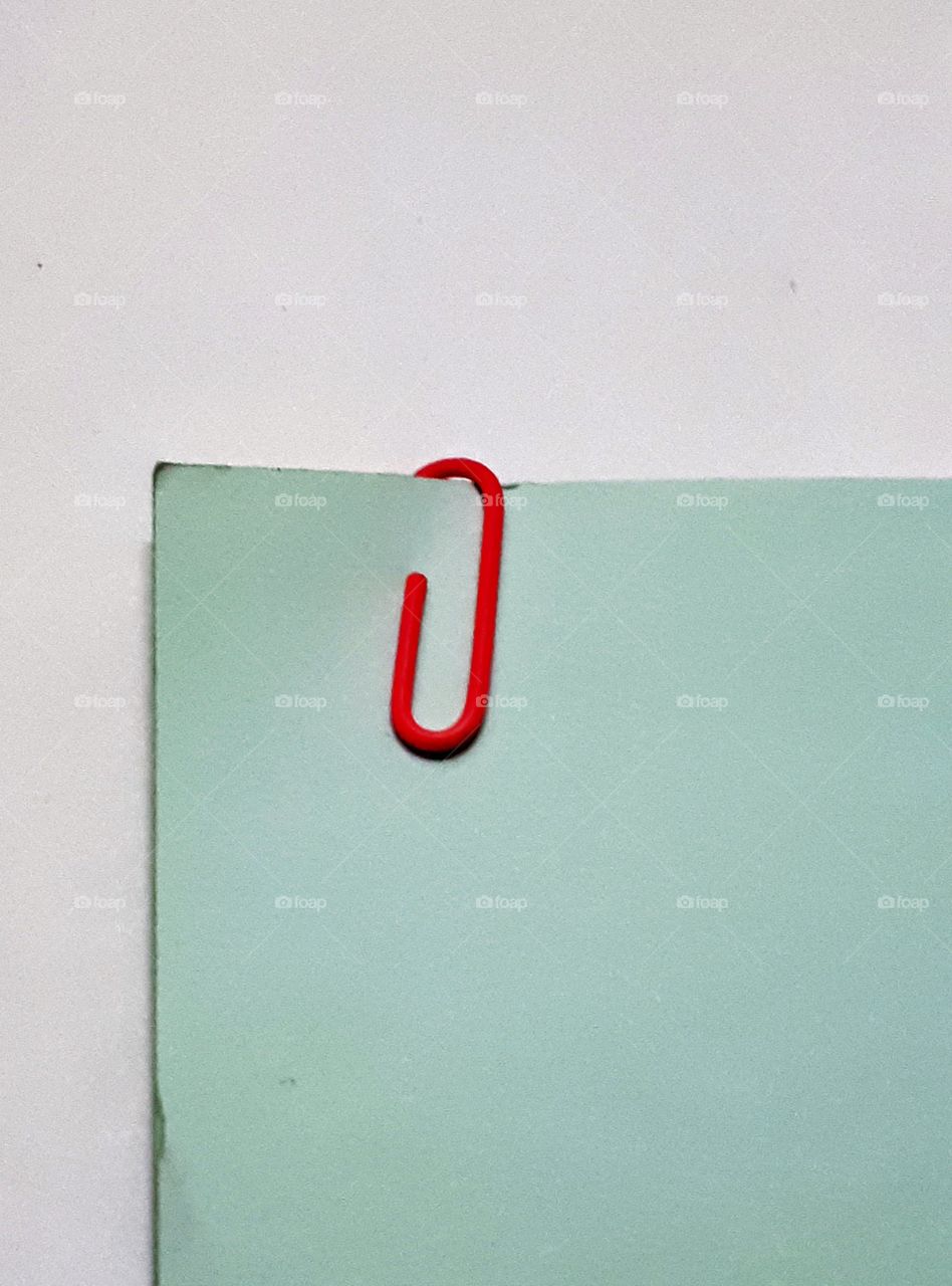 Paperclip holding papers together,white  background