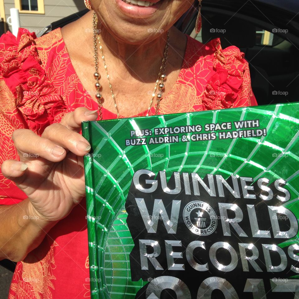 Auntie Bettie holding the Guinness Book of World Records! She holds the world record for most pairs of sunglasses.....1,500.  She is 87 and hopes to have 3000 pairs by the time she is 90.  Good luck auntie.