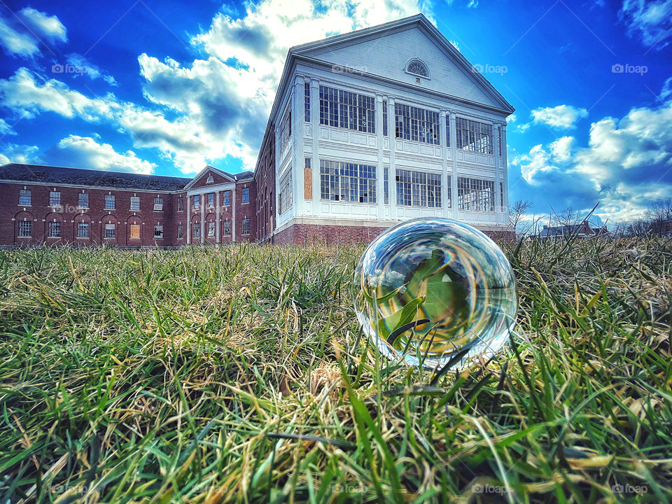 Crystal ball in front of a derelict building 