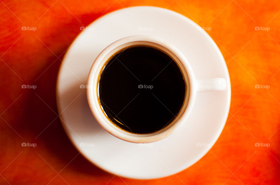 Espresso cup on orange table