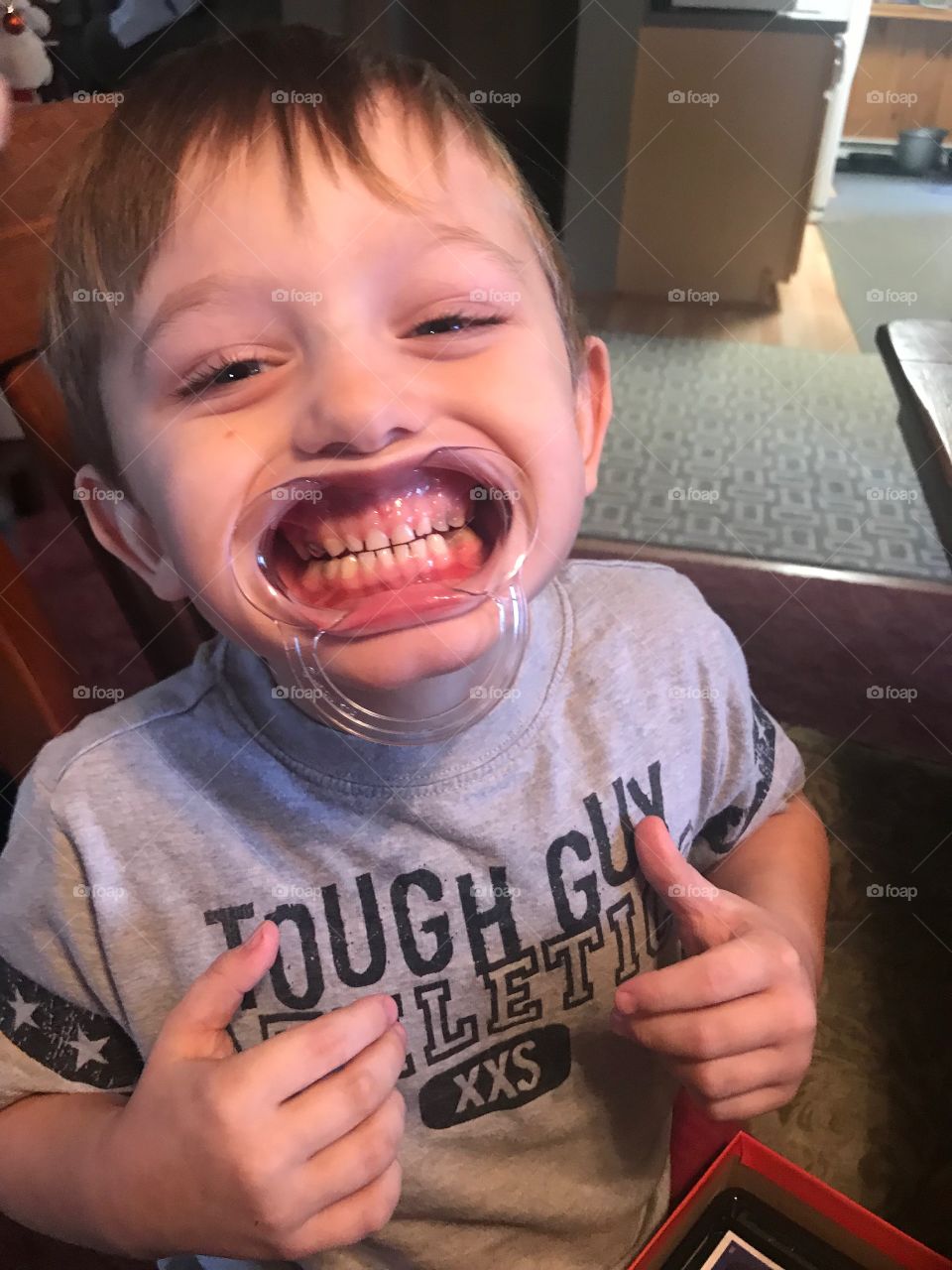 A wide mouthed cute little boy playing a silly game that makes us giggle. 