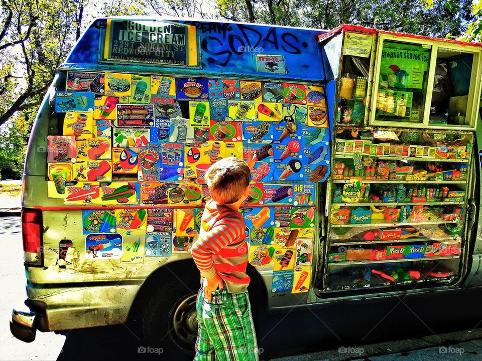 Young child at ice cream truck in summer