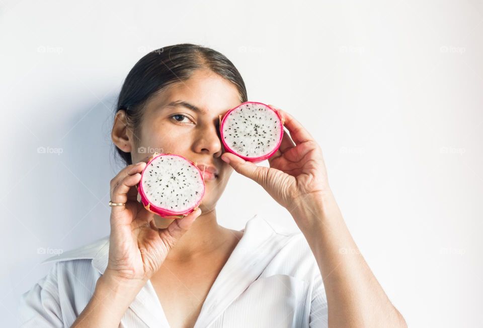 Circle shaped dragon fruit halves in my hands.