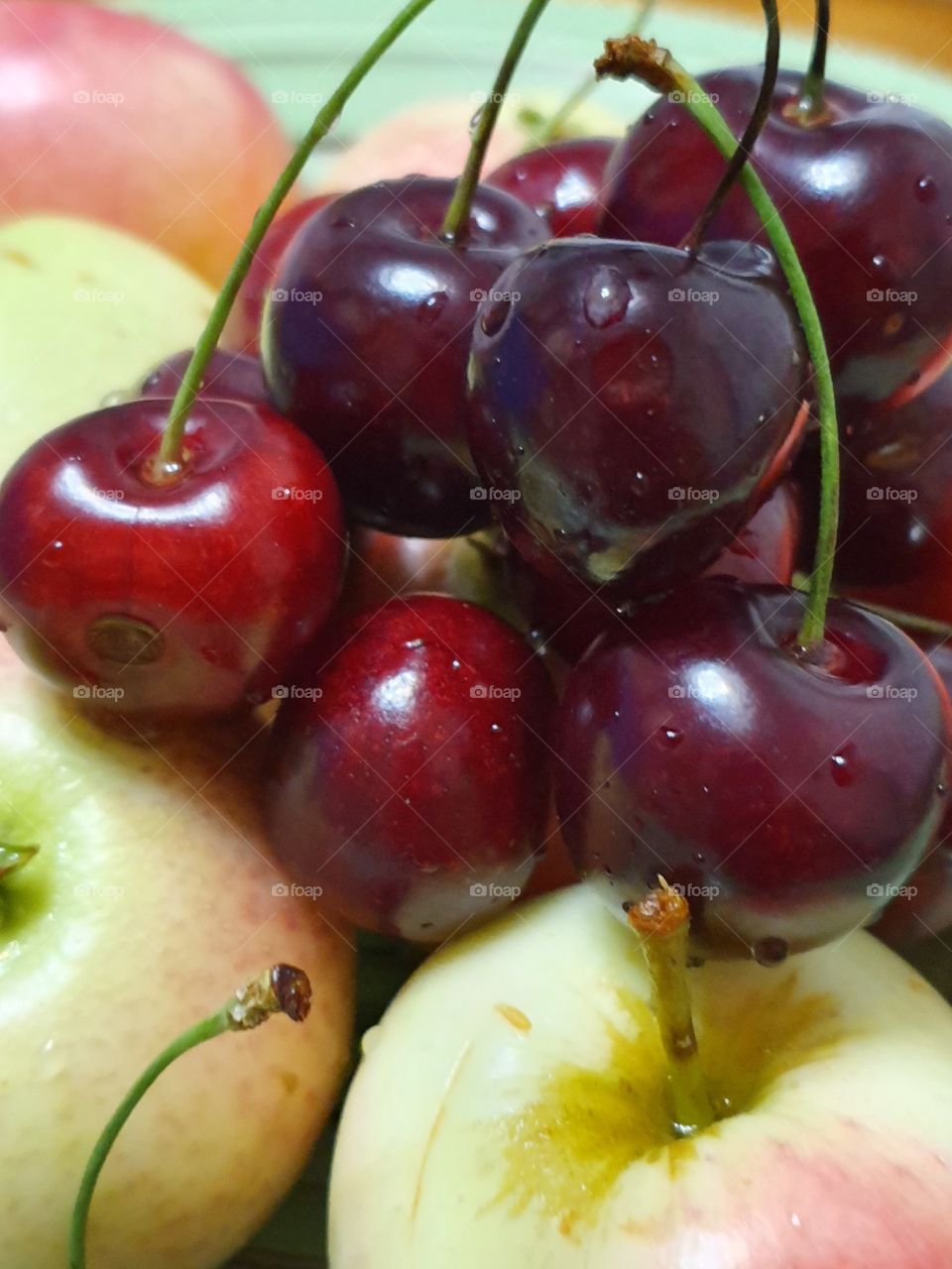 juicy and yummy apples and cherries closeup