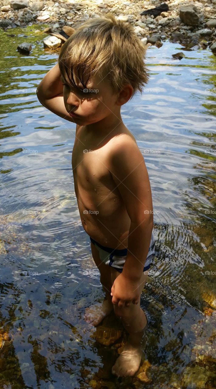 Boy wading creek