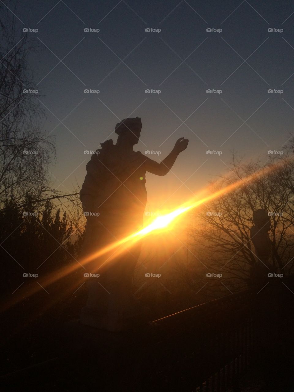 Sun and statue