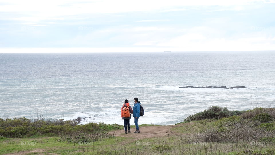 Hikers along the sea.