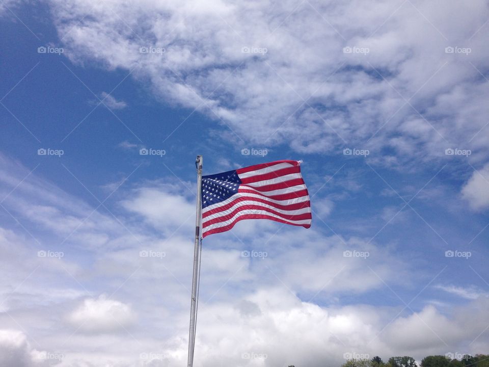 Flag flying free over blue skies