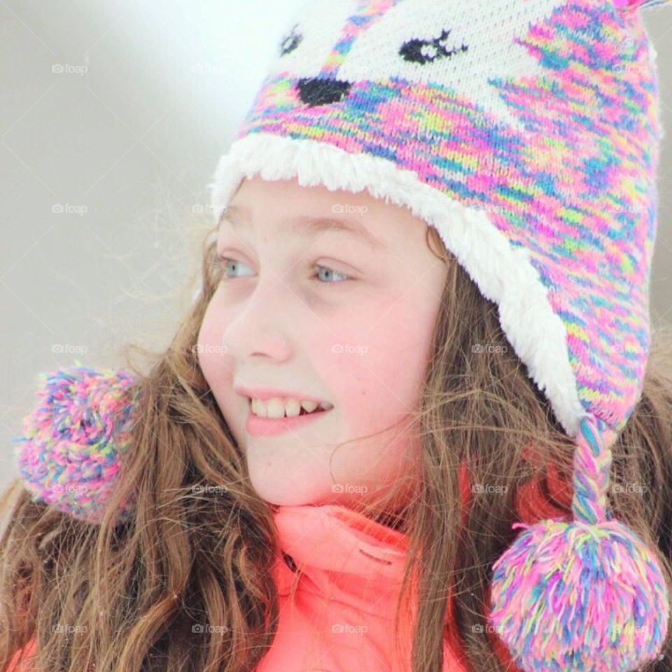 Looking up at the hill she plans to sled down. 