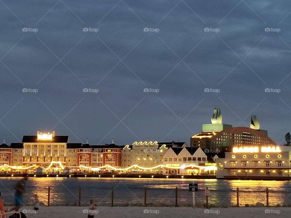 The lights shine bright as the sun finishes setting at Disney's Boardwalk.