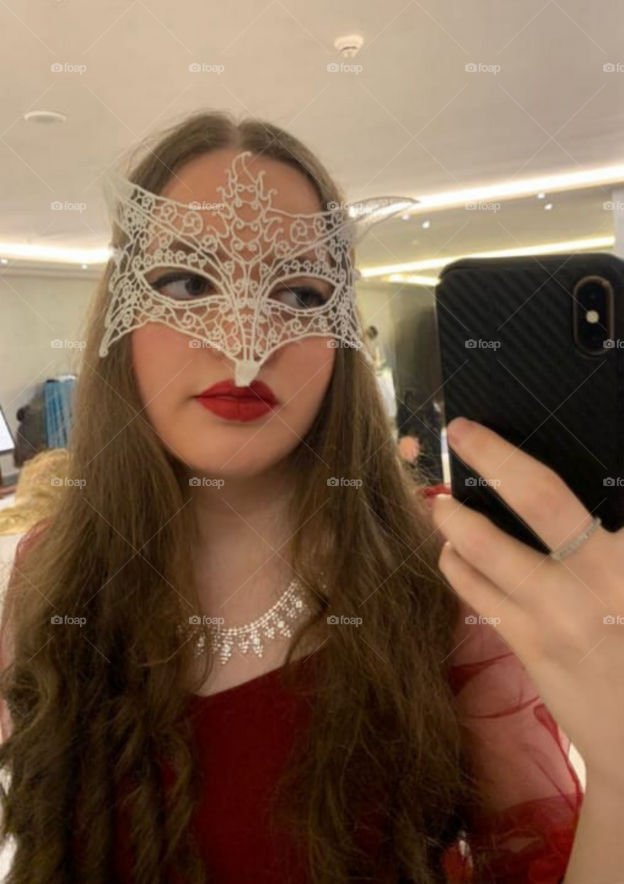girl at a masquerade party taking a selfie 🤳