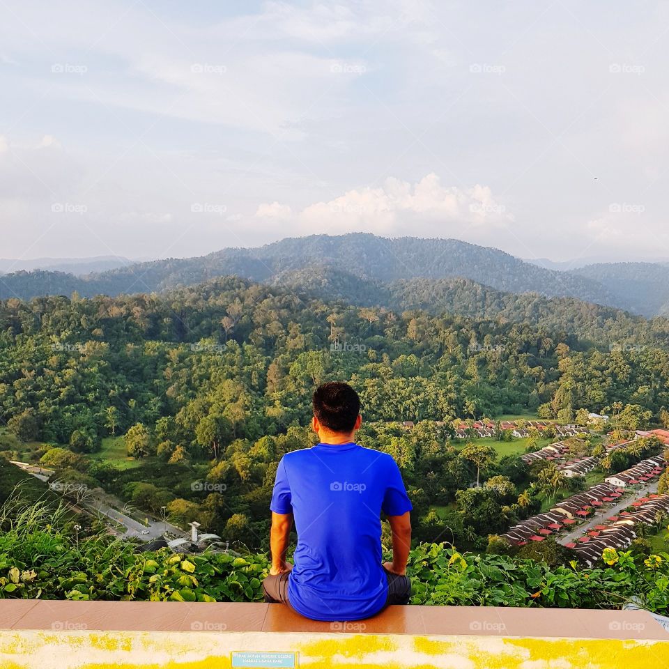 Man sitting alone on mountain