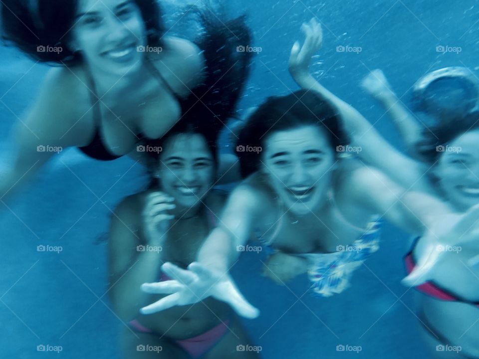 Group of girl swimming underwater