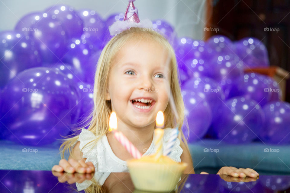 Birthday girl blowing candles