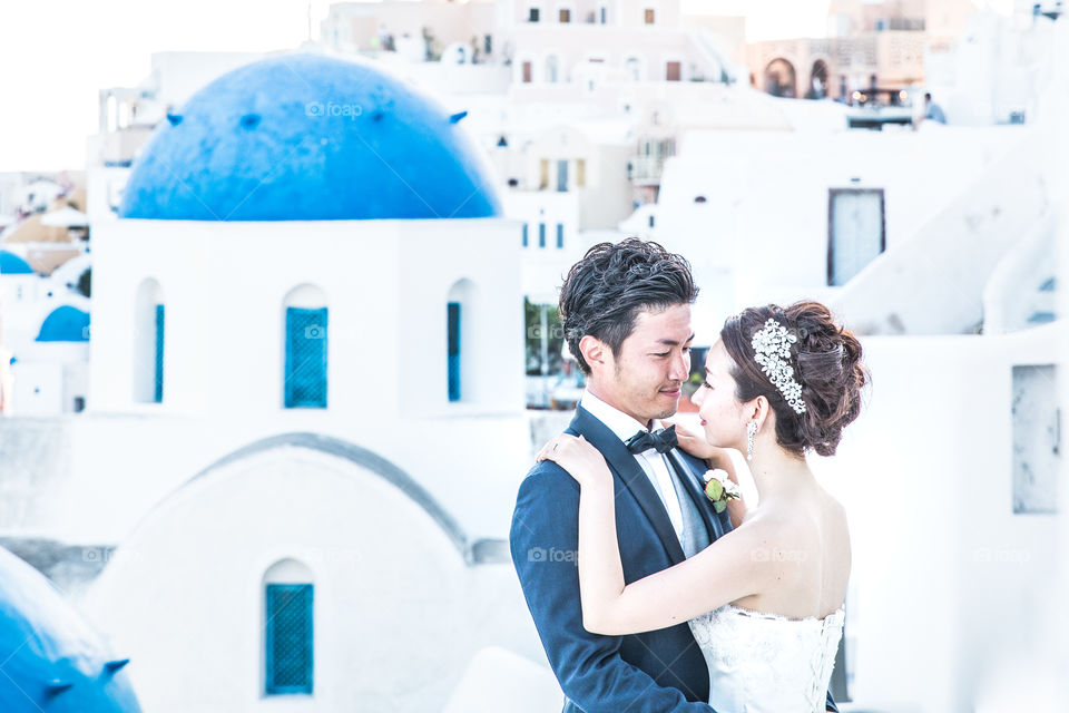 Young Wedding Couple In Famous Island Santorini In Greece
