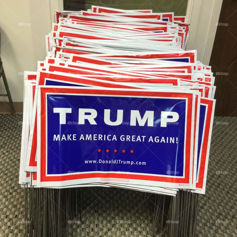 A large stack of political signs for Trump.