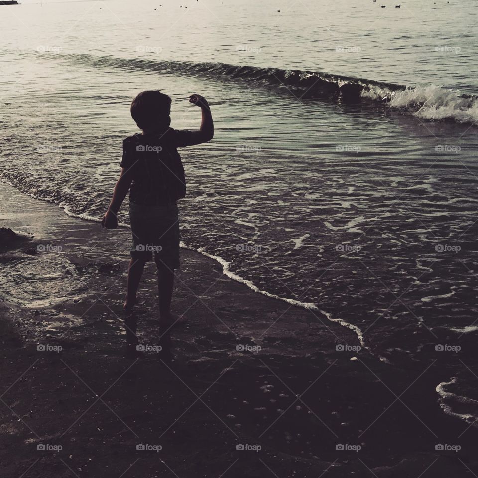 Boy skimming stones