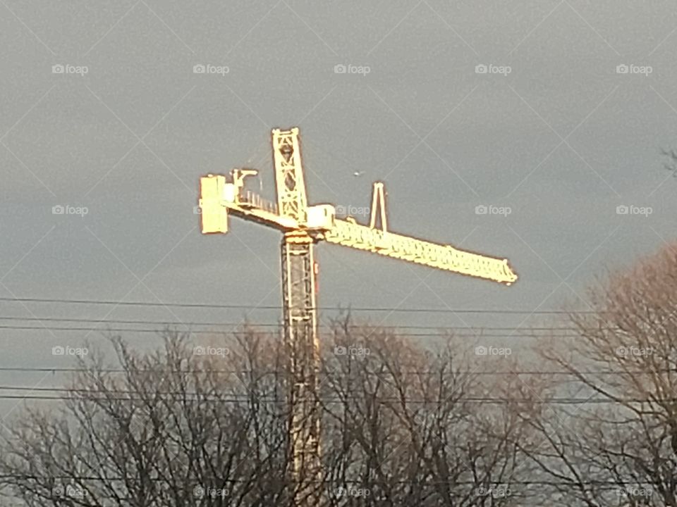 crane with sun reflecting on it
