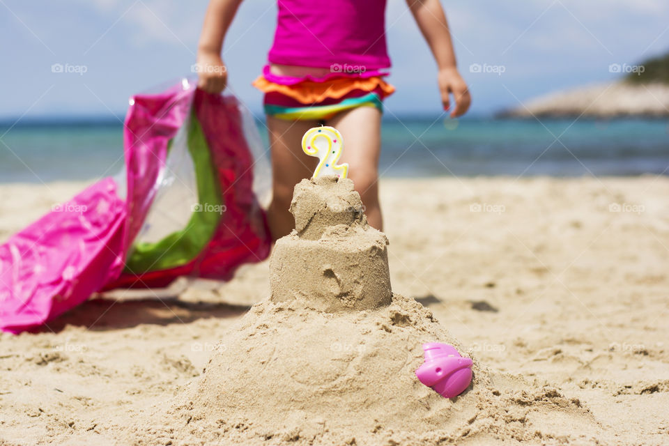 sandy cake on the beach. cake made of sand on the beach for child birthday