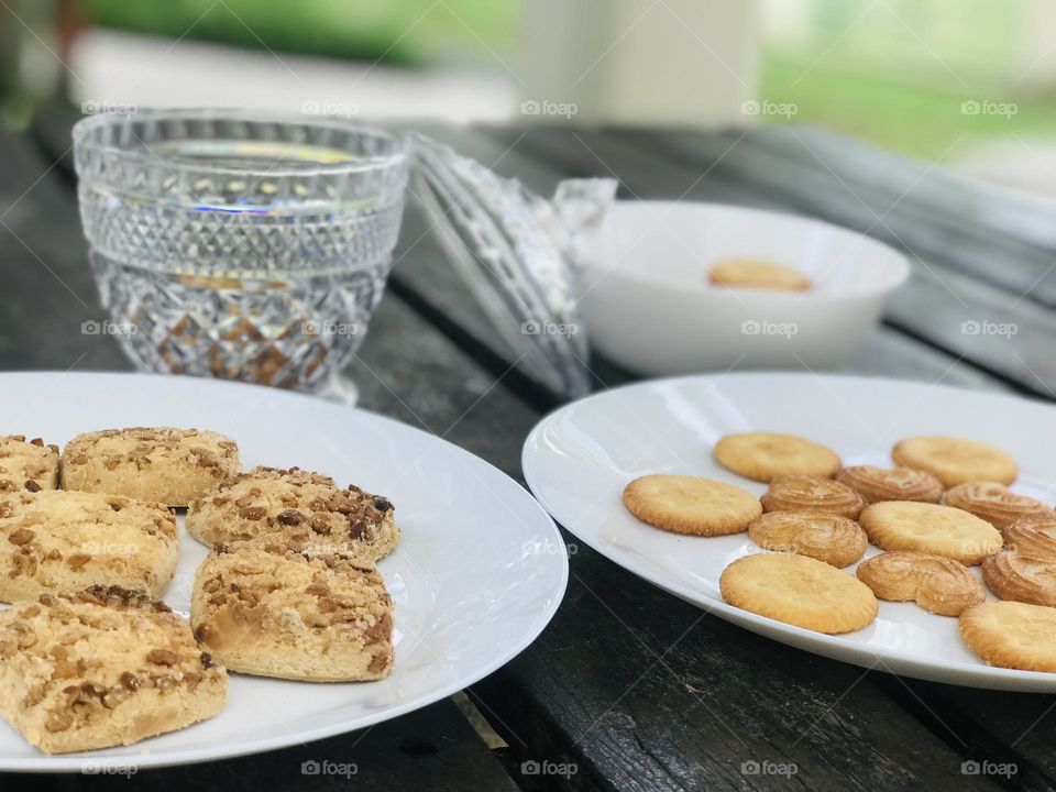 A plate full of cookies on outdoor table 