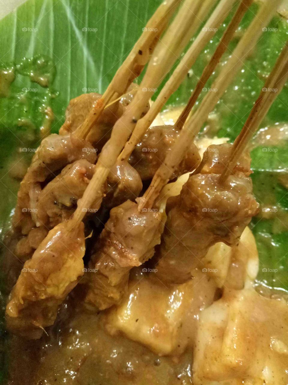 Padangnese Satay;  typically sold as street food in push cart in Indonesia. It served with thick sauce which almost curry like