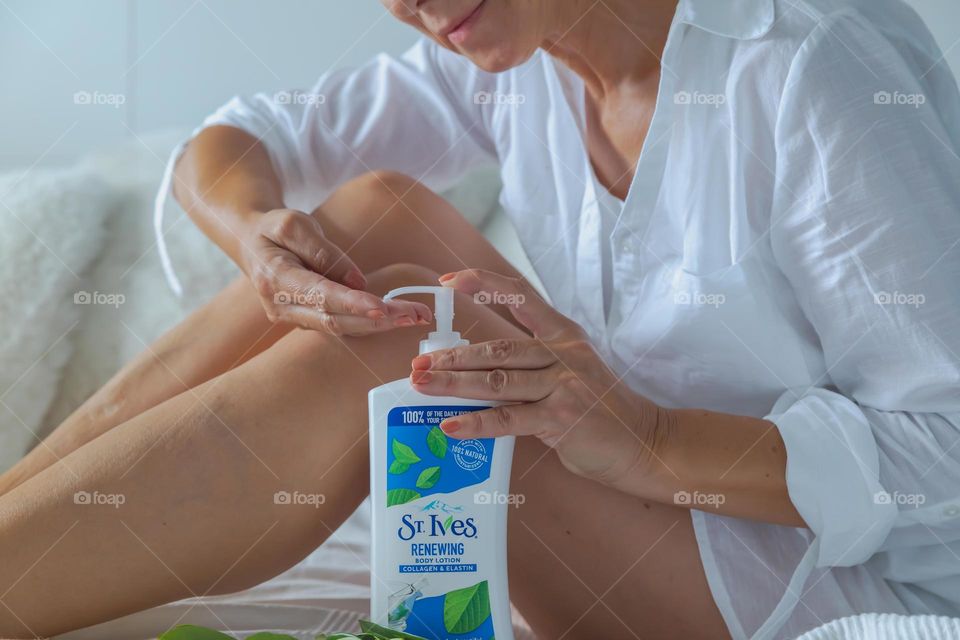 Woman  uses st. Ives Body Lotion on her legs