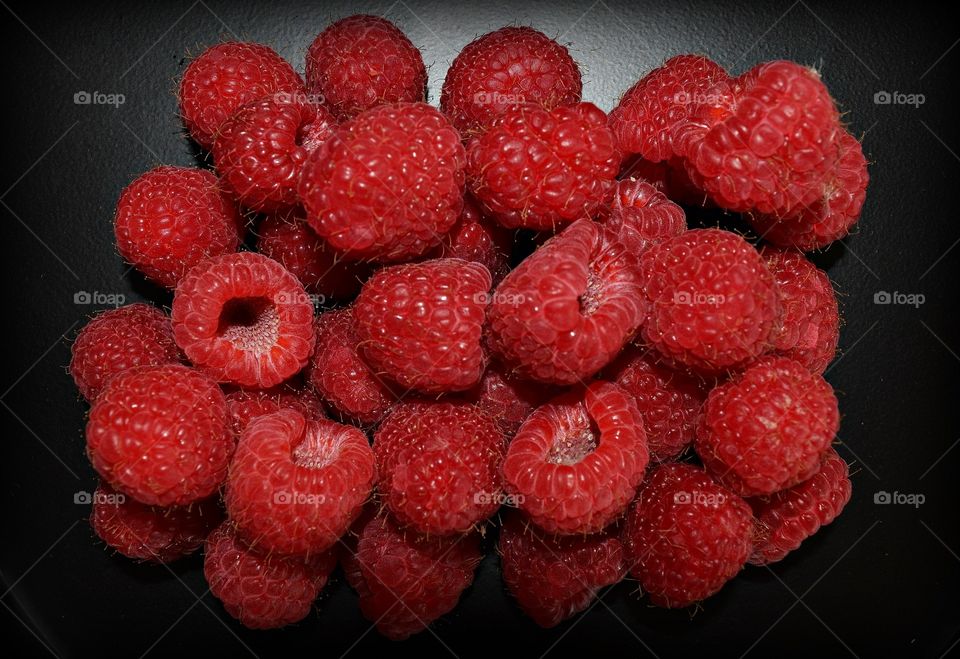 Raspberries on black background