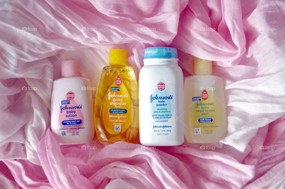 Johnson and Johnson baby products on a pink background flat lay 
