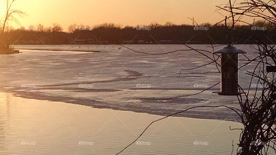 ice floating at sunset. birds ice lake sunset
