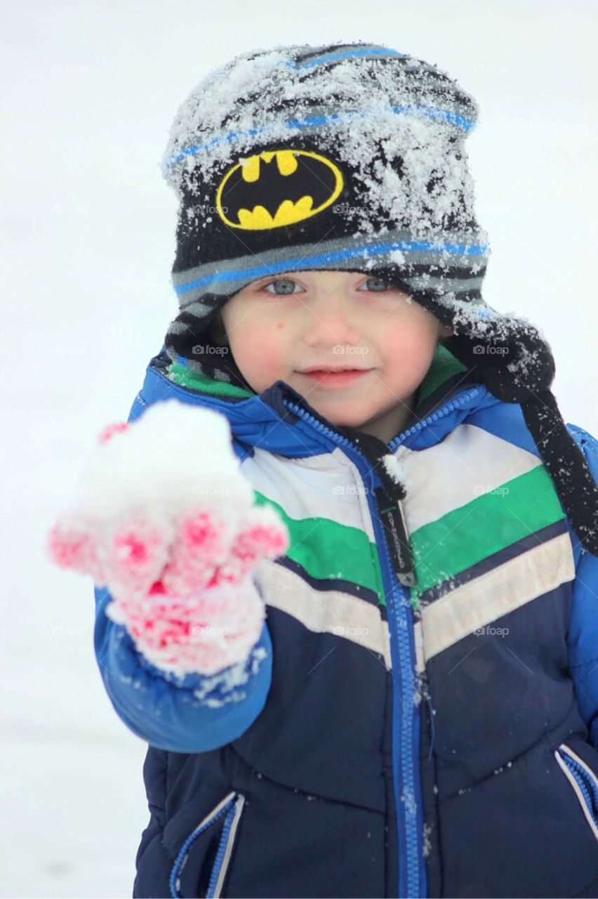 Boy holding snow