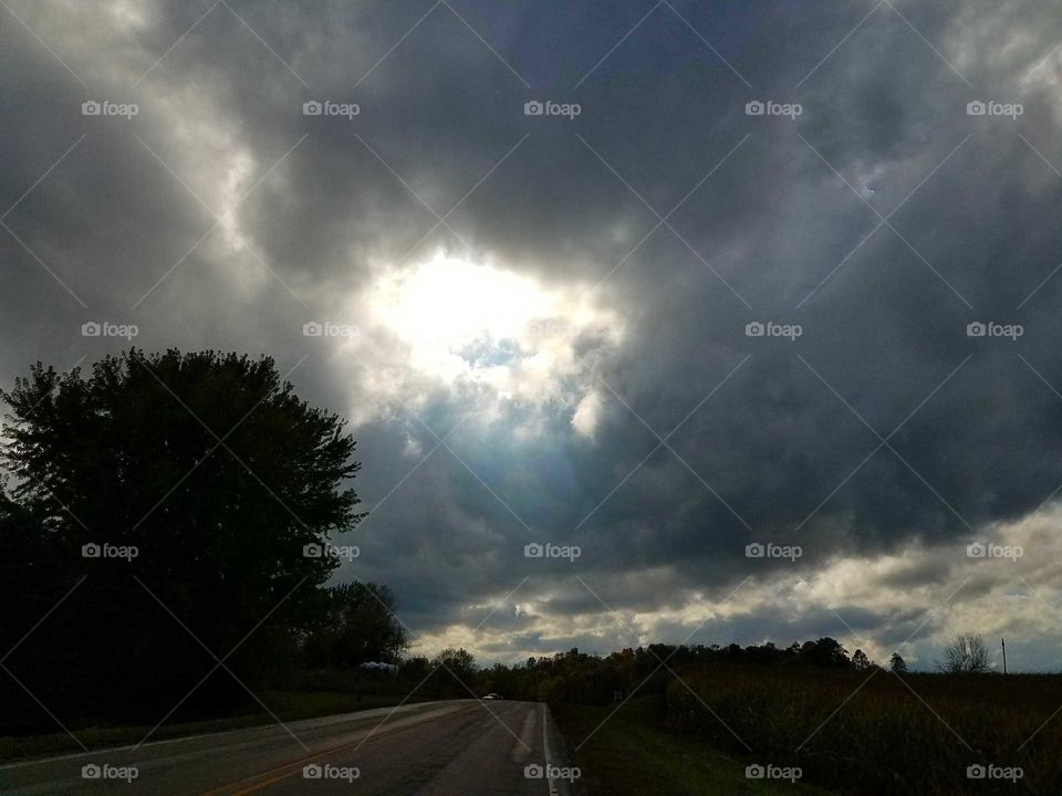 Driving the Back Roads and enjoying everything around us.  Sunset  shining trough the storm clouds.