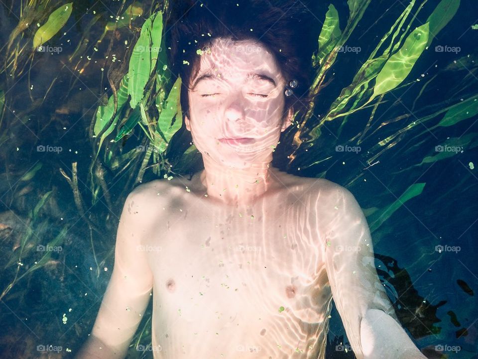 Boy submerged in a river