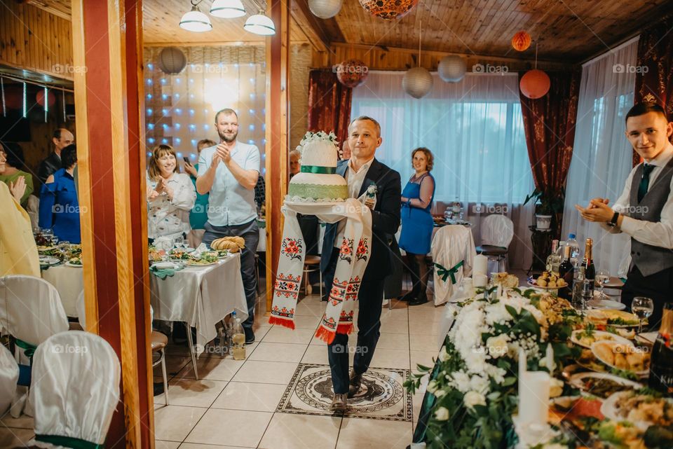 Godparents with a wedding loaf in Ukraine