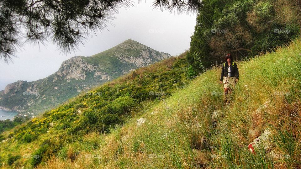 Female hiker walking on mountain